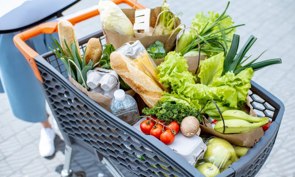 Shopping cart full of healthy food outdoors
