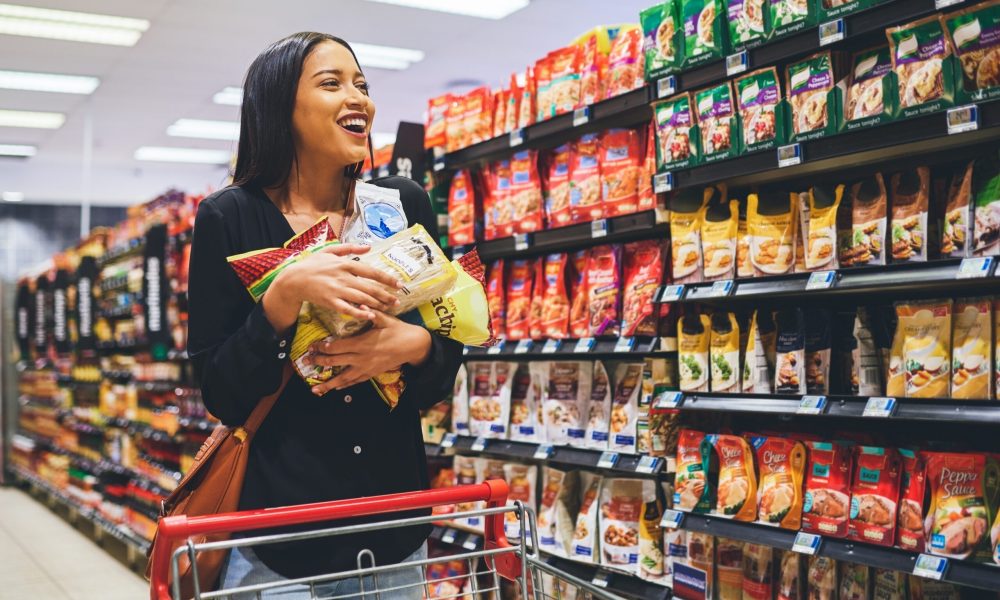 Shot of a young woman shopping in a grocery store